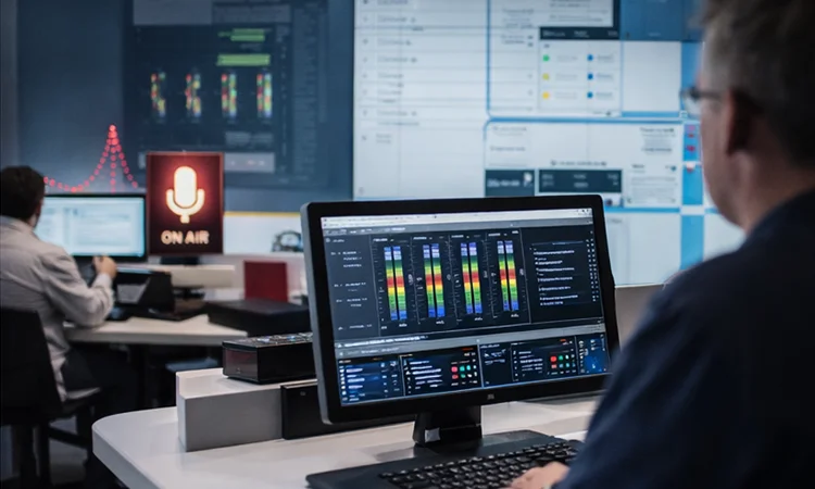 audio control room with technician monitoring system levels and audio performance
