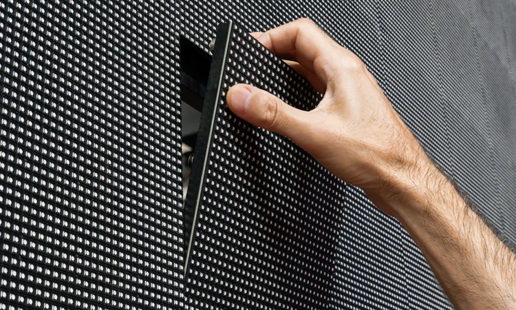 Pro AVL video solutions video wall detail Hand installing panel on video wall
