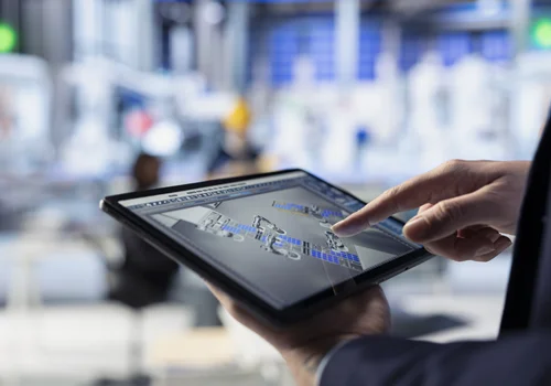 Engineer reviewing AV system design and network architecture using a tablet control interface.