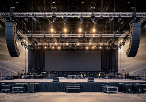 Structural rigging system supporting lighting, audio, and LED display equipment in a large venue environment.