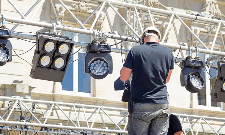 technicians operating rigging control system during setup