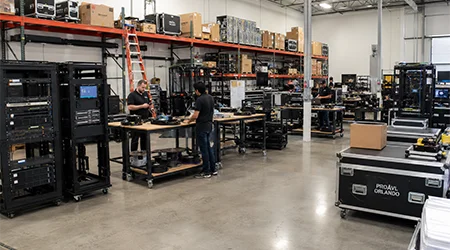 Pro AVL Orlando Corporate Office warehouse with AV equipment racks and technicians preparing systems