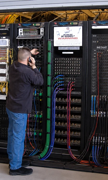AV Equipment Rack Installation at FP&L Training Facility AV technician configuring equipment racks and structured cabling during training facility audio video system installation