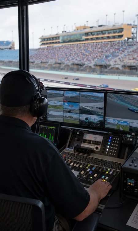 Homestead-Miami Speedway Broadcast Control Room Broadcast control room overlooking a banked turn at Homestead-Miami Speedway with production monitors, network racks, and operator controls.