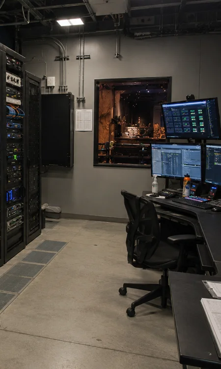 King Kong Show Control and AV Systems Room Backstage show control room with AV equipment racks, media playback systems, and attraction control infrastructure supporting a themed entertainment environment.